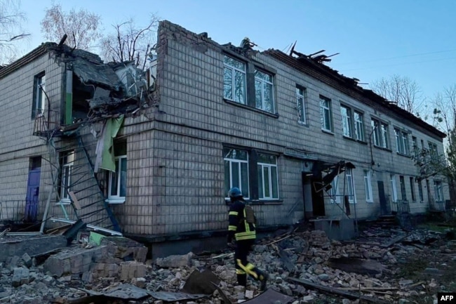 Esta fotografía tomada y publicada por el Servicio de Emergencia de Ucrania el 25 de noviembre de 2023 muestra a un rescatista trabajando en el lugar de un ataque con drones en Kiev. (Foto de Handout / Servicio de Emergencia de Ucrania / AFP)