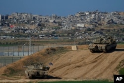 Israeli soldiers take up positions near the Gaza Strip border, in southern Israel, Jan.7, 2024.