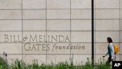 FILE - A person walks by the headquarters of the Bill and Melinda Gates Foundation on April 27, 2018, in Seattle. 