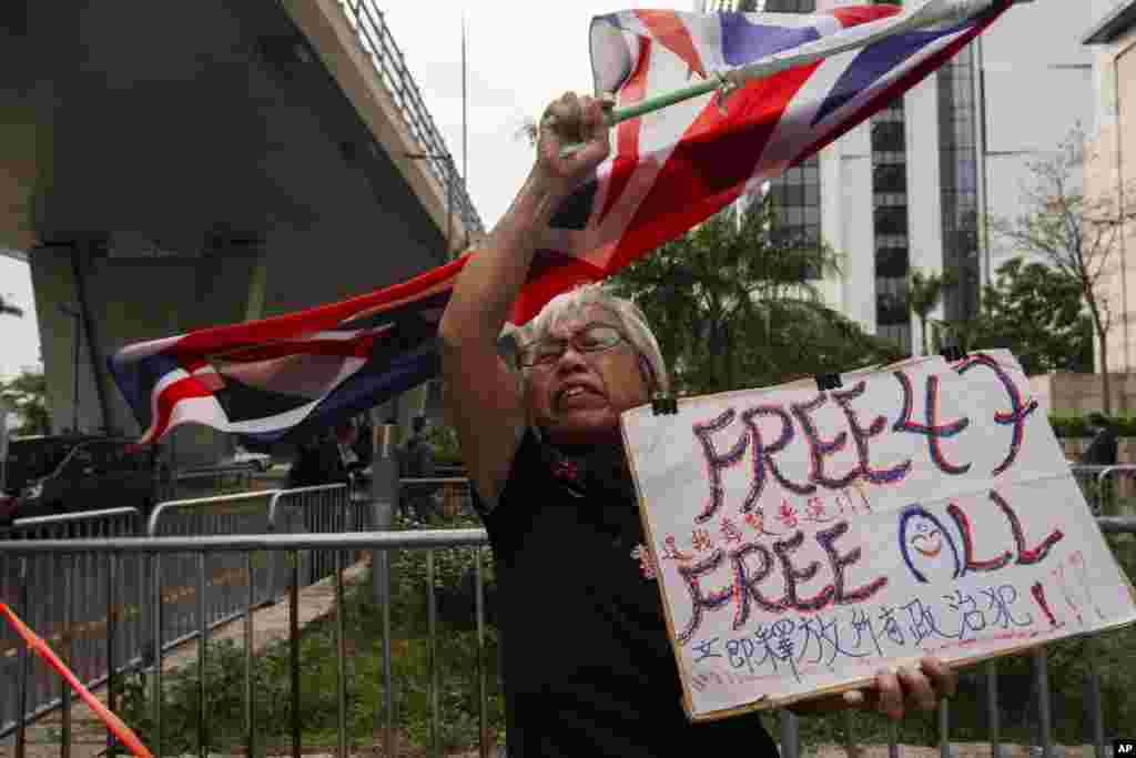 A pro-democracy activist known as &quot;Grandma Wong&quot; protests outside the West Kowloon courts as closing arguments open in Hong Kong&#39;s largest national security trial of 47 pro-democracy figures. (AP Photo/Louise Delmotte)