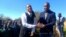 Felix Silundika presenting prize to a student