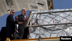 United Nations Secretary-General Antonio Guterres inspects aid for Palestinians, as officials wait to deliver aid to Gaza through the Rafah border crossing between Egypt and the Gaza Strip, at Al Arish airport, in Egypt, Oct. 20, 2023.