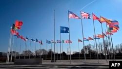 FILE - An empty mast is seen among NATO member nation flags at alliance headquarters in Brussels, Feb. 27, 2024, ahead of a flag-raising ceremony for Sweden’s accession to NATO, approved by lone hold-out Hungary March 5, 2024.