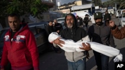 Palestinians mourn their relatives killed in the Israeli bombardment of the Gaza Strip, in the hospital in Khan Younis, Nov. 21, 2023.