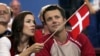 FILE - Crown Prince Frederik and Crown Princess Mary of Denmark speak prior to the start of the Olympic Group B women's handball match between Denmark and France in the Faliro Sports Pavilion, at the Olympic Games 2004 in Athens, Aug. 15, 2004. 