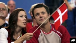 FILE - Crown Prince Frederik and Crown Princess Mary of Denmark speak prior to the start of the Olympic Group B women's handball match between Denmark and France in the Faliro Sports Pavilion, at the Olympic Games 2004 in Athens, Aug. 15, 2004. 