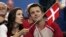 FILE - Crown Prince Frederik and Crown Princess Mary of Denmark speak prior to the start of the Olympic Group B women's handball match between Denmark and France in the Faliro Sports Pavilion, at the Olympic Games 2004 in Athens, Aug. 15, 2004. 