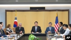 In this photo provided by South Korea Presidential House via Yonhap, South Korean President Yoon Suk Yeol, center, speaks during a meeting of the Nuclear Consultative Group between South Korea and the United States in Seoul, July 18, 2023.