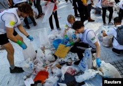 Anggota tim Inggris memilah sampah yang mereka kumpulkan selama kompetisi memungut sampah "Spogomi World Cup" di Tokyo, Jepang 22 November 2023. (REUTERS/Kim Kyung-Hoon)