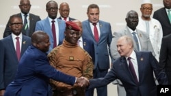 FILE - Russian President Vladimir Putin, right, and Mozambique President Filipe Nyusi shake hands at the Russia Africa Summit in St. Petersburg, Russia, July 28, 2023. Putin denies he is seeking to oust Western influence in Africa. "We're just being friends with them," he said. 