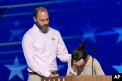 Jon Polin and Rachel Goldberg, parents of Hersh Goldberg-Polin, speak on stage during the Democratic National Convention, Aug. 21, 2024, in Chicago.