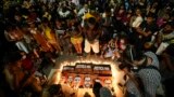 FILE - Guarani Indigenous people and activists attend a vigil in Sao Paulo, Brazil, June 23, 2022, asking for justice in the deaths of British journalist Dom Phillips and Indigenous expert Bruno Pereira.
