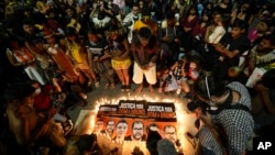 FILE - Guarani Indigenous people and activists attend a vigil in Sao Paulo, Brazil, June 23, 2022, asking for justice in the deaths of British journalist Dom Phillips and Indigenous expert Bruno Pereira.