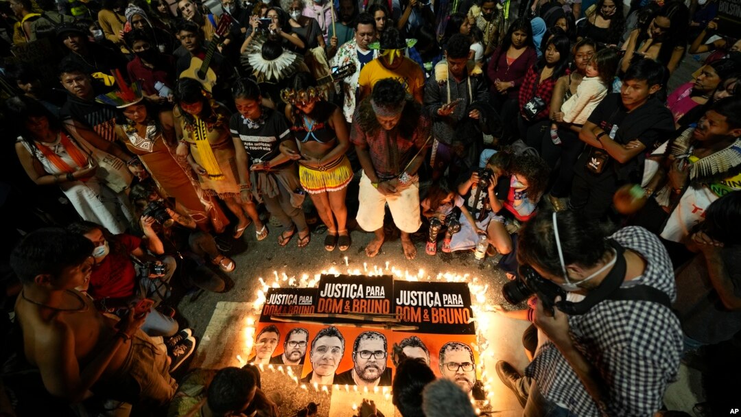 FILE - Guarani Indigenous people and activists attend a vigil in Sao Paulo, Brazil, June 23, 2022, asking for justice in the deaths of British journalist Dom Phillips and Indigenous expert Bruno Pereira.