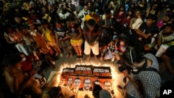 FILE - Guarani Indigenous people and activists attend a vigil in Sao Paulo, Brazil, June 23, 2022, asking for justice in the deaths of British journalist Dom Phillips and Indigenous expert Bruno Pereira.