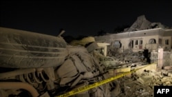 A general view of damaged cars and buildings at the scene of an explosion in the Bodija area in Ibadan, Jan. 16, 2024. 