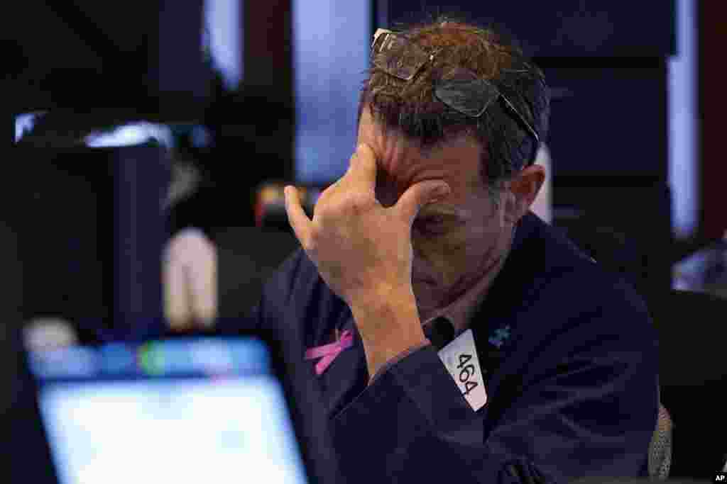 Trader Gregory Rowe works on the floor of the New York Stock Exchange.&nbsp;Nearly everything on Wall Street is tumbling as fear about a slowing U.S. economy worsens and sets off another sell-off for financial markets around the world.