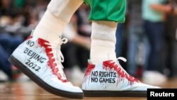 FILE - Enes Kanter Freedom wore these shoes urging that China not host the 2022 Winter Olympic Games when the Boston Celtics hosted the Chicago Bulls in Boston, Nov 1, 2021.