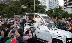 FILE - Pope Francis waves from his popemobile in Rio de Janeiro, Brazil, July 26, 2013. While in Rio for World Youth Day that year, he urged young people to make a "mess" in their churches, to shake things up even if it ruffled feathers.