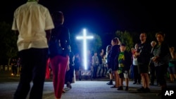 FILE - The faithful attend a 'Via Crucis' (Way of the Cross) at the St. Gabriele dell'Addolorata sanctuary in Isola del Gran Sasso near Teramo in central Italy, July 29, 2023.