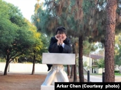 Arkar Chen poses for a photo at graduation.