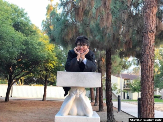 Arkar Chen poses for a photo at graduation.