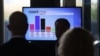 People look at a screen with the first exit polls results for Thuringia's state elections, at the State Parliament in Erfurt, eastern Germany, Sept. 1, 2024. 