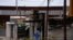 A forensic technician works at a scene where a man threw a Molotov cocktail bomb at a bar after being kicked out, according police, in San Luis Rio Colorado, Mexico July 22, 2023.