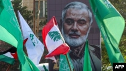 A portrait of slain Hamas leader Ismail Haniyeh is displayed during a demonstration denouncing his killing, in the Lebanese coastal city of Sidon, on Aug. 2, 2024.