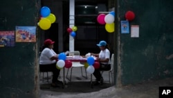 Ruling party grassroots organizers sort documents and propaganda about the Essequibo region during a referendum about the future of a disputed territory with Guyana, in Caracas, Venezuela, Dec. 3, 2023.