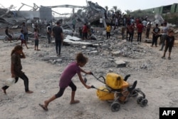 Palestinians inspect the site of an Israeli strike in Zawayda in the central Gaza Strip on Aug. 17, 2024.