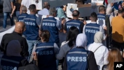 FILE - Palestinian journalists are seen during a protest march heading toward a United Nations office in the West Bank city of Ramallah, Nov. 7, 2023.