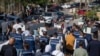 FILE - Palestinian journalists carry mock coffins of colleagues killed during the current Israel-Hamas war, during a symbolic funeral procession toward a United Nations office in the West Bank city of Ramallah, Nov. 7, 2023.