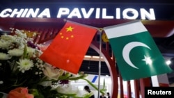 FILE - Flags of Pakistan and China are seen at the entrance to the China Pavilion, during the International Defense Exhibition and Seminar "Ideas 2022" in Karachi, Pakistan, Nov. 16, 2022.