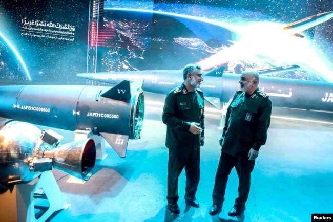 Commander-in-Chief of the Islamic Revolution Guards Corps Hossein Salami and IRGC Aerospace Force Commander Amir Ali Hajizadeh stand next to the new hypersonic ballistic missile called Fattah, in Tehran, Iran, June 6, 2023. (IRGC/WANA/Handout via Reuters)