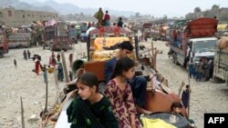 Afghan refugees arrive with their belongings on trucks from Pakistan at the Afghanistan-Pakistan Torkham border in Nangarhar province.&nbsp;Hundreds of thousands of Afghans living in Pakistan faced the threat of detention and deportation on November 1.(Photo by Wakil KOHSAR / AFP)