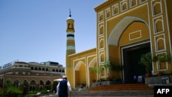 FILE - This picture taken on July 14, 2023, shows a Uyghur man outside the Id Kah Mosque in Kashgar city in northwestern China's Xinjiang region.