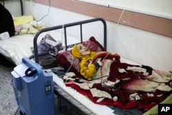 A 10-year-old Palestinian, Yazan al-Kafarna, who was born with cerebral palsy, lies at a hospital in Rafah, March 3, 2024. He died a day later due to what his doctor said was muscle wastage caused mostly by a lack of food, which his family struggled to find since fleeing home.