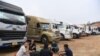 FILE - Truck drivers gather at a makeshift parking lot where Vietnamese container trucks are waiting to cross the Vietnam-China border in Lang Son province on Jan. 7, 2022.