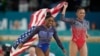 Simone Biles, left, celebrates with teammate Suni Lee, of the U.S., after winning the gold and bronze medals respectively in the women's artistic gymnastics all-around finals in Bercy Arena at the 2024 Summer Olympics in Paris, Aug. 1, 2024.