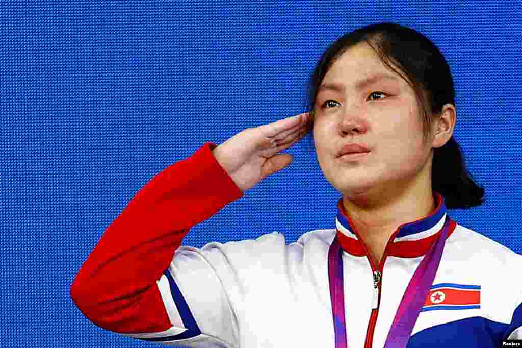 North Korea&#39;s gold medalist Kim Ilgyong salutes during the medal ceremony of the women&#39;s 59Kg Group A weightlifting of the 19th Asian Games in Hangzhou, China. REUTERS/Kim Kyung-Hoon