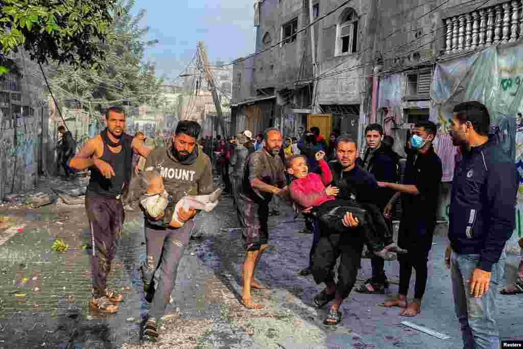 Palestinians carry wounded children following an Israeli strike on a house, after a temporary truce between Hamas and Israel expired, in Rafah, in the southern Gaza Strip.