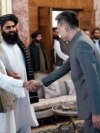 FILE - China's ambassador to Afghanistan, Zhao Sheng, greets Prime Minister Mohammad Hasan Akhund at the Presidential Palace in Kabul, Sept. 13, 2023. China recently accepted the credentials of the Taliban ambassador to Beijing. (Taliban handout via AP)
