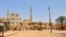 A few people walk outside Abdul Hayy mosque in Khartoum's Jabra neighborhood, on May 28, 2023, as many residents of the area have fled the ongoing fighting between two rival generals. 
