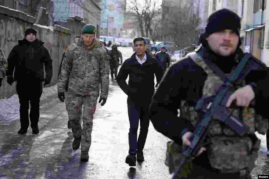 British Prime Minister Rishi Sunak and Vice Chief of the Defence Staff, Major General Gwyn Jenkins, left, are shown damaged buildings in Kyiv, Ukraine, ahead of meeting with President Volodymyr Zelenskyy to announce a major new package of military aid to Ukraine.