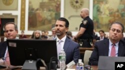 Donald Trump Jr. sits in the courtroom with his legal team before the continuation of a civil business fraud trial at New York Supreme Court, in New York, Nov. 13, 2023.