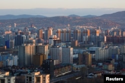 The sun rises over Ulaanbaatar, the capital of Mongolia, May 1, 2018. On Friday, Mongolian police raided the office of a local news outlet in Ulaanbaatar.