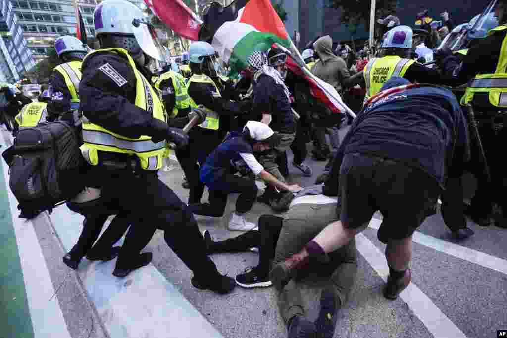 Demonstrators clash with police near the Israeli Consulate during the Democratic National Convention, Aug. 20, 2024, in Chicago. 