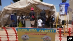 FILE - A family is seen entering a tent set up for suspected cholera patients at a clinic in Harare, Zimbabwe, Nov. 18, 2023.