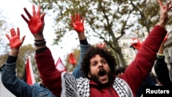 People attend a demonstration demanding a cease-fire in Gaza, an end to airstrikes and an end to forcible displacement of populations amid the ongoing conflict between Israel and Palestinian Islamist group Hamas, in Paris, Nov. 4, 2023. 